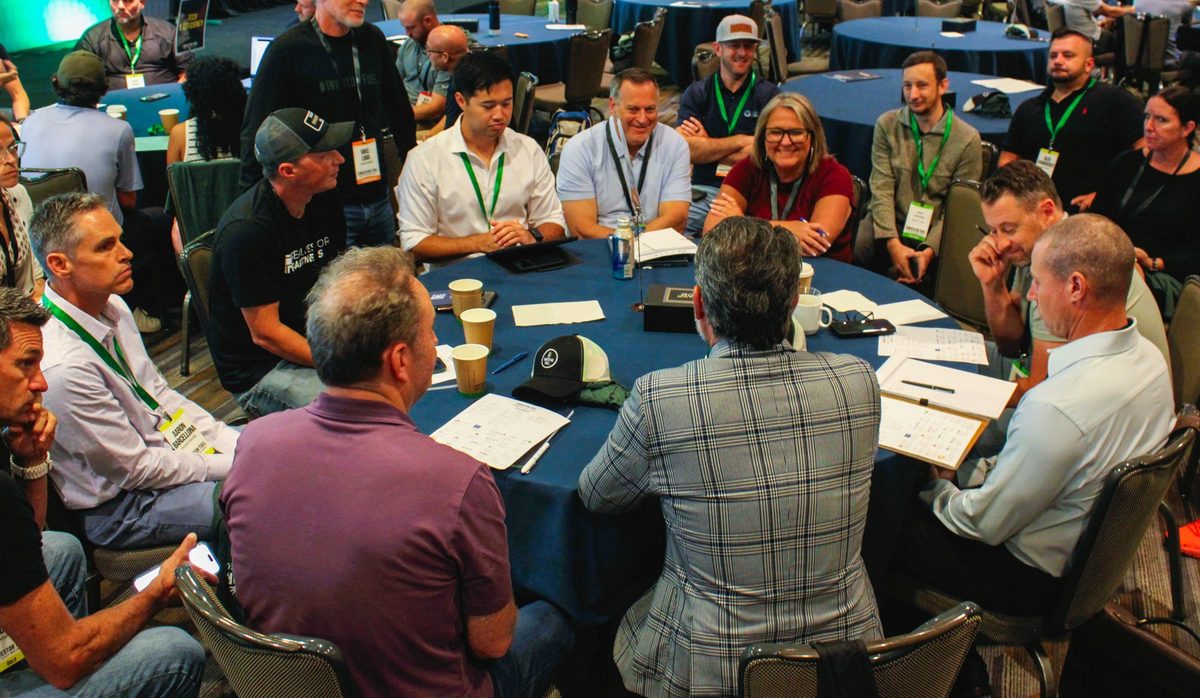 A breakout table of members laughing over notes